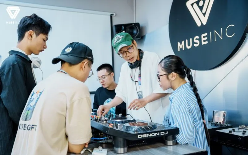 A Muse Inc instructor teaching a student on DJ equipment
