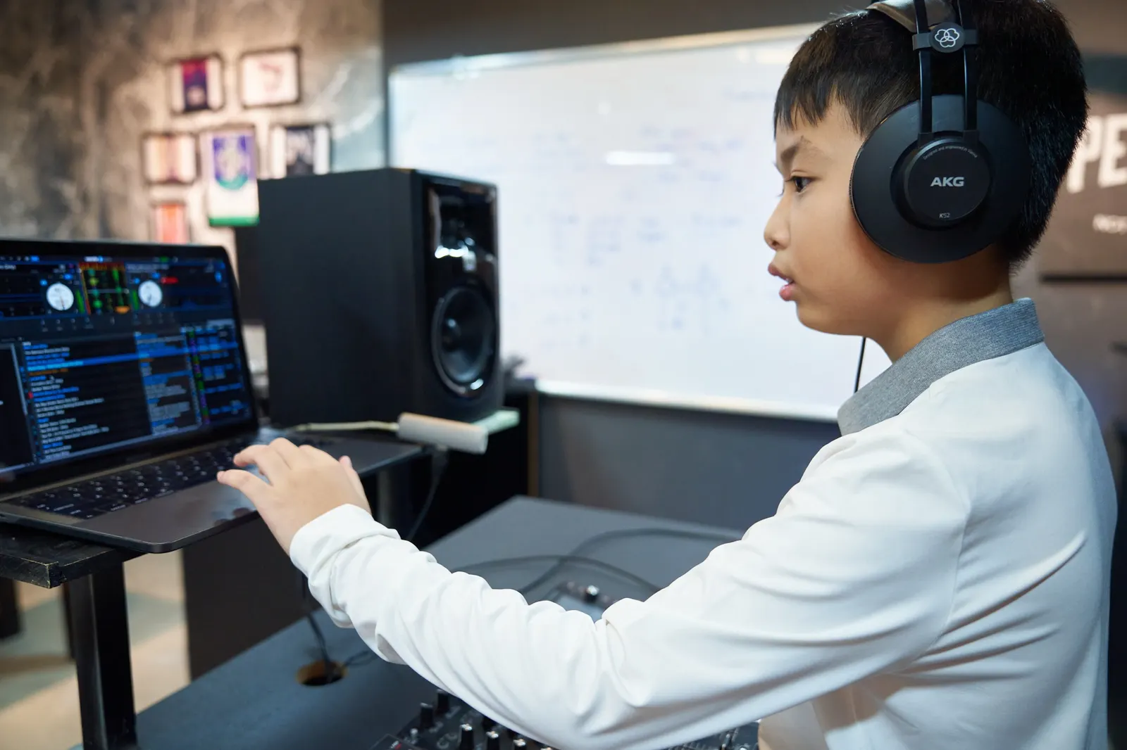 A child learning DJ equipment at Muse Academy